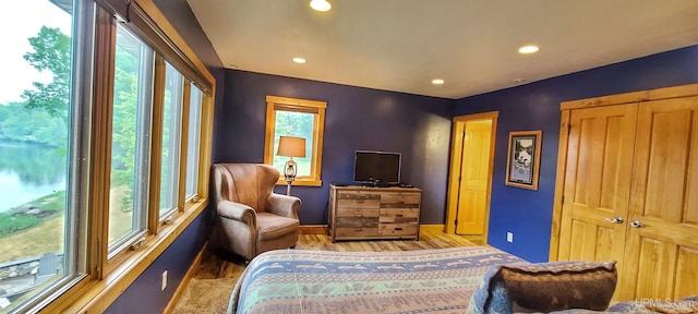 bedroom featuring light wood-type flooring and a closet