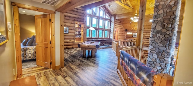 interior space with high vaulted ceiling, rustic walls, beamed ceiling, and hardwood / wood-style flooring