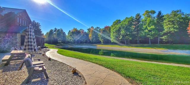 exterior space with a lawn and a water view