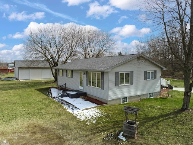 back of house featuring a garage and a yard