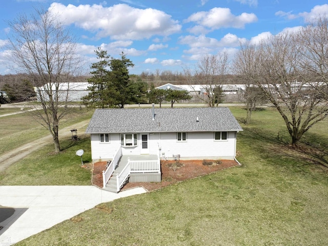 rear view of property featuring a lawn