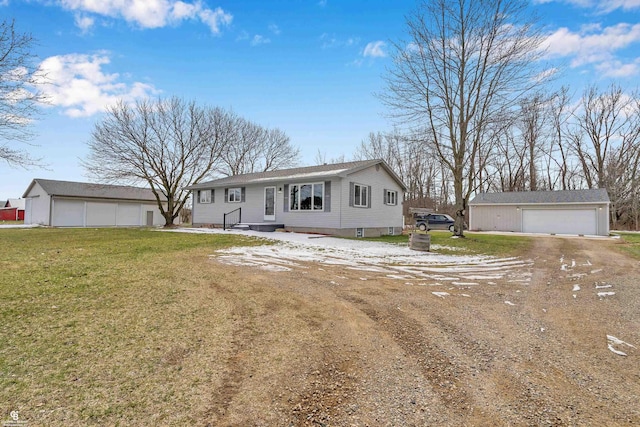 view of front facade featuring a front yard, a garage, and an outdoor structure