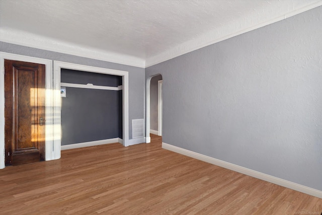 unfurnished bedroom with a closet and hardwood / wood-style floors