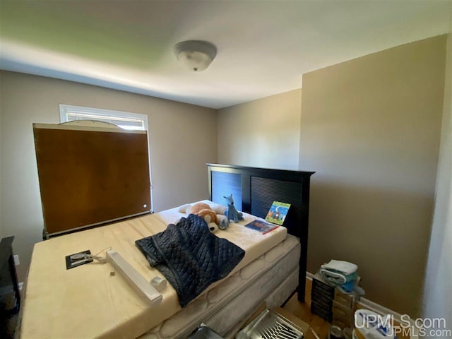 bedroom with wood-type flooring