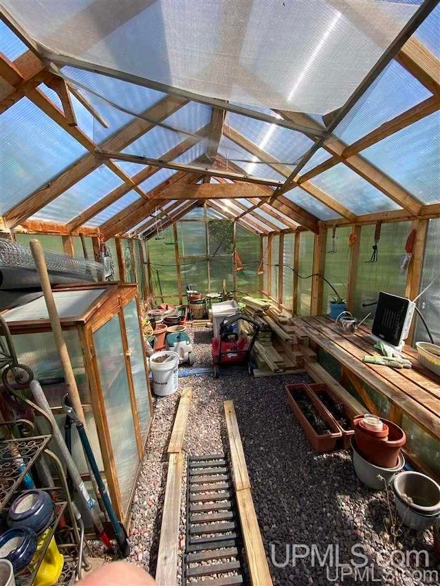 unfurnished sunroom with lofted ceiling