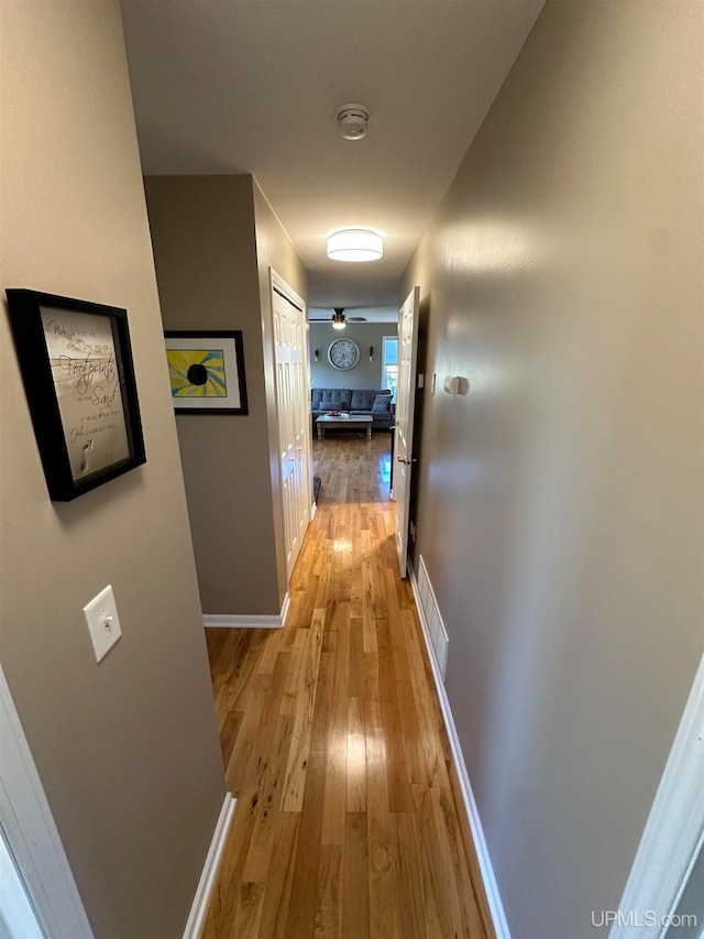 corridor with light hardwood / wood-style floors