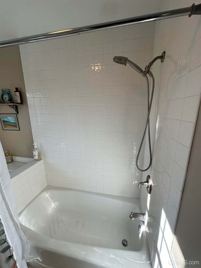 bathroom featuring shower / bathtub combination with curtain