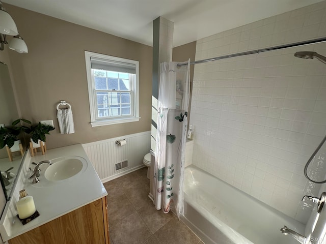 full bathroom with tile patterned flooring, vanity, toilet, and shower / bath combo with shower curtain