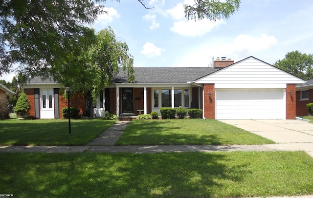 ranch-style home featuring a garage and a front yard