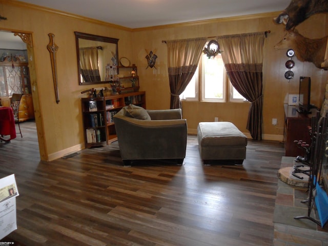 living area with ornamental molding and dark hardwood / wood-style flooring