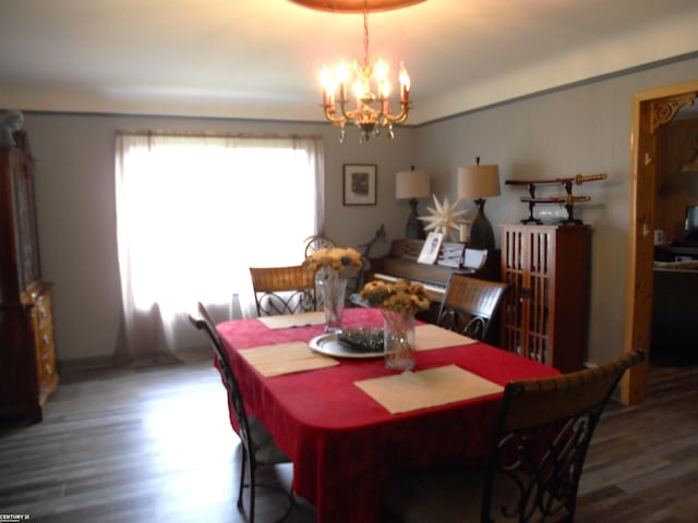 dining space with an inviting chandelier and wood-type flooring