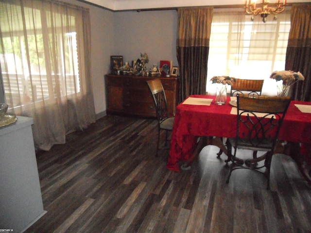 dining room featuring plenty of natural light, dark hardwood / wood-style flooring, and a chandelier