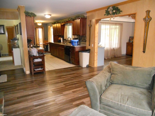 living room with light hardwood / wood-style floors and sink