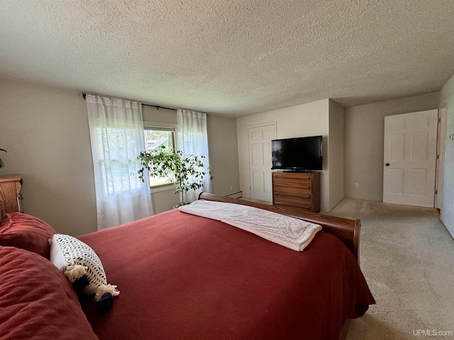 bedroom featuring light colored carpet, a textured ceiling, and a baseboard radiator