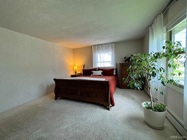 bedroom with a textured ceiling and light colored carpet