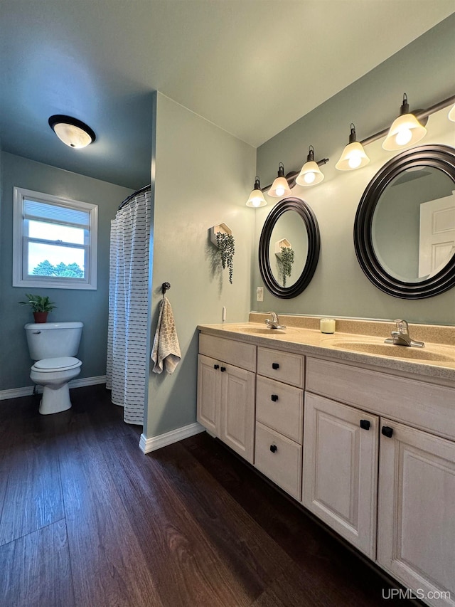 bathroom with vanity, toilet, and hardwood / wood-style flooring