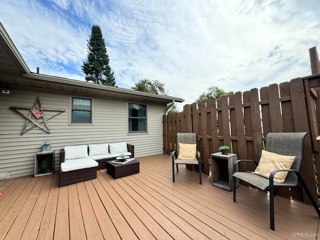 wooden terrace with an outdoor hangout area