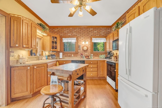 kitchen with light hardwood / wood-style floors, range, white fridge, ornamental molding, and ceiling fan