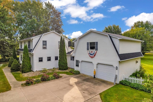 view of front of house featuring a garage and a front lawn