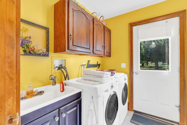 laundry room featuring cabinets, light tile patterned floors, washer and dryer, and sink