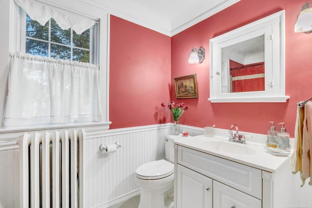 bathroom featuring crown molding, radiator, toilet, and vanity