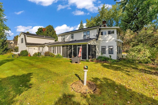 back of house featuring a yard and a sunroom