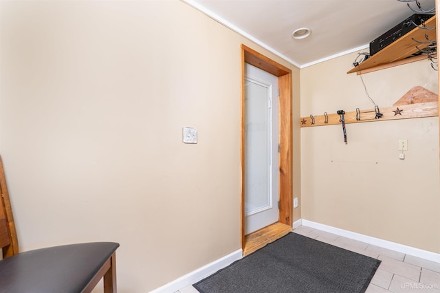 doorway to outside with light tile patterned flooring