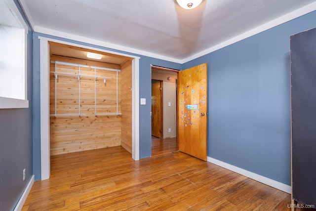 unfurnished bedroom featuring a closet and hardwood / wood-style flooring