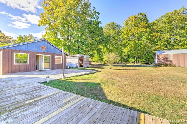 view of yard with a wooden deck and an outbuilding