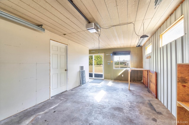 interior space featuring wood ceiling and a garage door opener