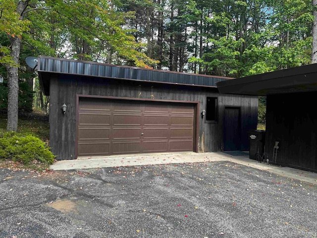 garage featuring wooden walls