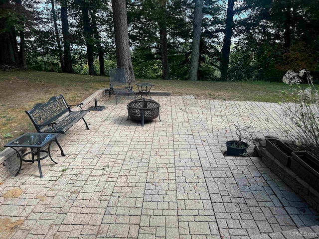 view of patio / terrace featuring an outdoor fire pit