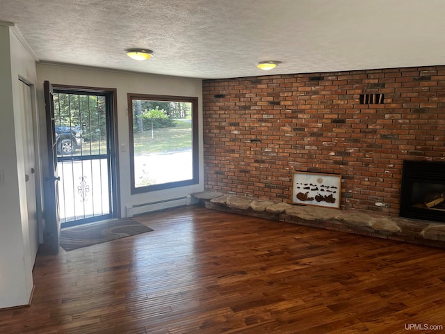 unfurnished living room with ornamental molding, dark hardwood / wood-style flooring, and a baseboard heating unit