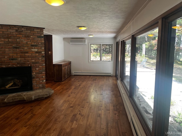 interior space with a baseboard radiator, a fireplace, and a wall unit AC