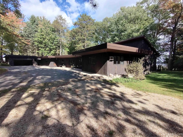 view of side of home with a garage and a yard