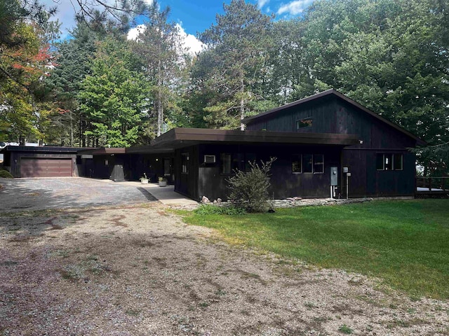 view of side of property with a lawn and a garage