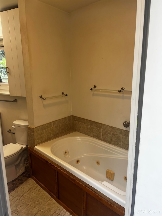 bathroom featuring a bath, tile patterned floors, and toilet