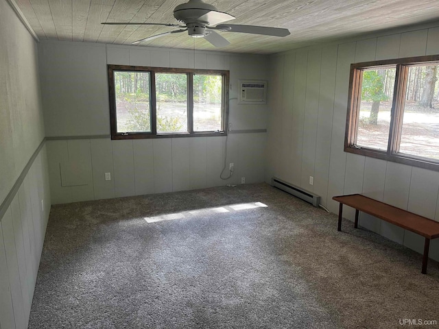 unfurnished room with carpet flooring, a baseboard heating unit, a healthy amount of sunlight, and a wall mounted air conditioner