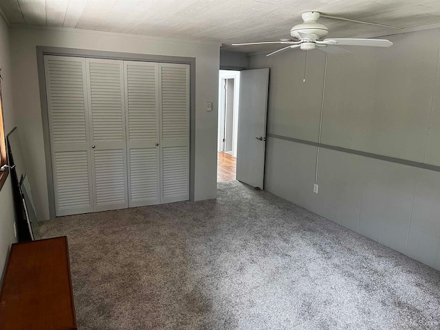 unfurnished bedroom featuring ceiling fan and carpet floors