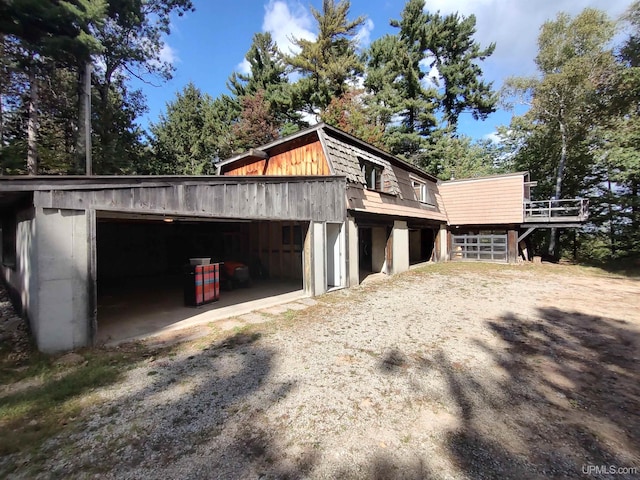 view of property exterior with an outdoor structure