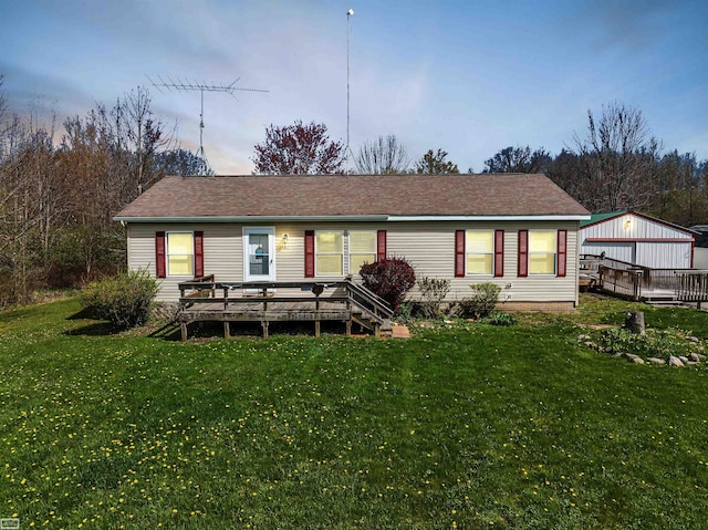 view of front of property with a lawn and a wooden deck