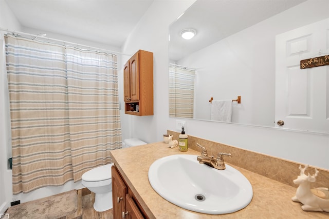 bathroom with wood-type flooring, vanity, and toilet