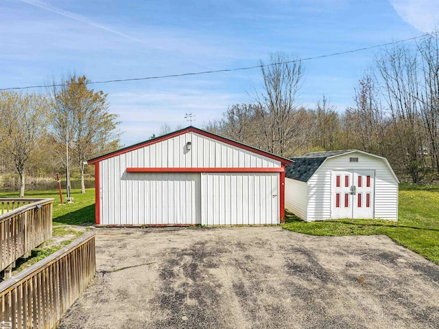 view of outbuilding featuring a lawn