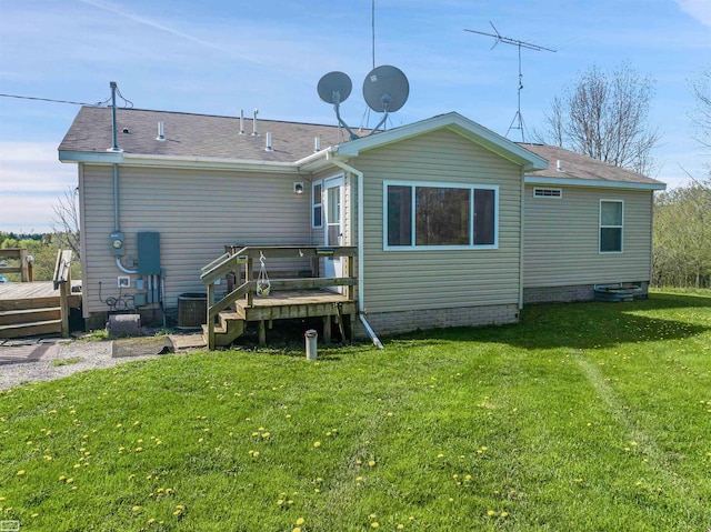 back of house with a wooden deck and a lawn