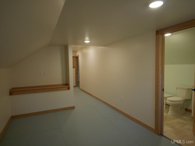 additional living space with baseboards, lofted ceiling, and recessed lighting