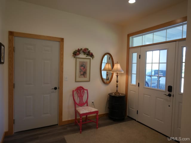 foyer entrance with wood finished floors, baseboards, plenty of natural light, and recessed lighting