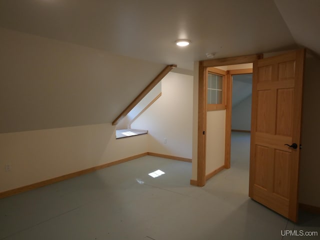 additional living space featuring baseboards, vaulted ceiling, and recessed lighting