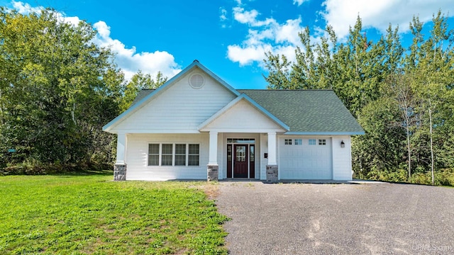 view of front of property with a garage and a front lawn