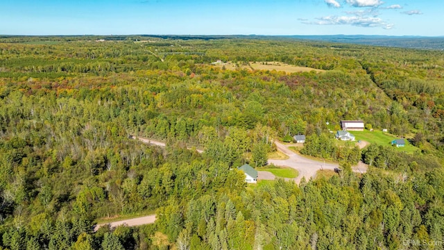 bird's eye view featuring a wooded view