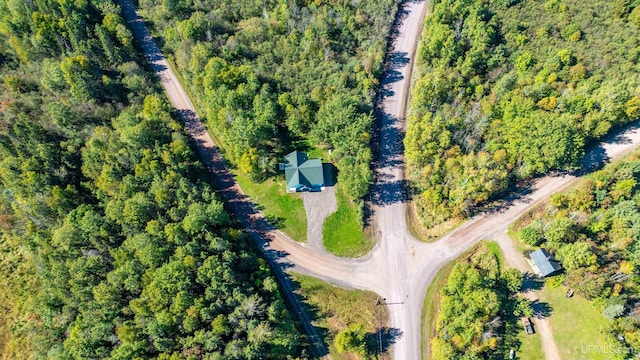 drone / aerial view featuring a wooded view